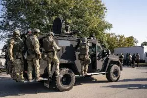 For More Sports And Politics Content: Secretary of Homeland Security Kristi Noem, not shown, visits with U.S. Immigration and Customs Enforcement officers at the ICE facility in Chicago to observe enforcement operations, Oct. 3, 2025. (DHS photo by Tia Dufour)