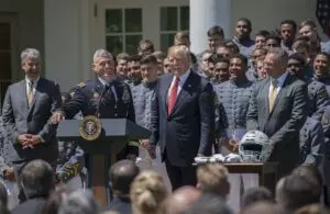 Lt. Gen. Robert L. Caslen Jr., the U.S. Military Academy superintendent, shares a laugh with President Donald Trump during the presentation of the Commander-in-Chief's Trophy, which the Army football team earned after it beat Navy and Air Force last season. Players also gave the president a team helmet and jersey during the ceremony at the White House in Washington, D.C., May 1, 2018. (Photo Credit: U.S. Army photo by Sean Kimmons)